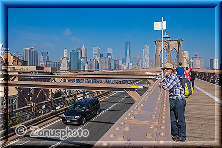 Frau schaut auf die Fahrbahn der Brooklyn Bridge